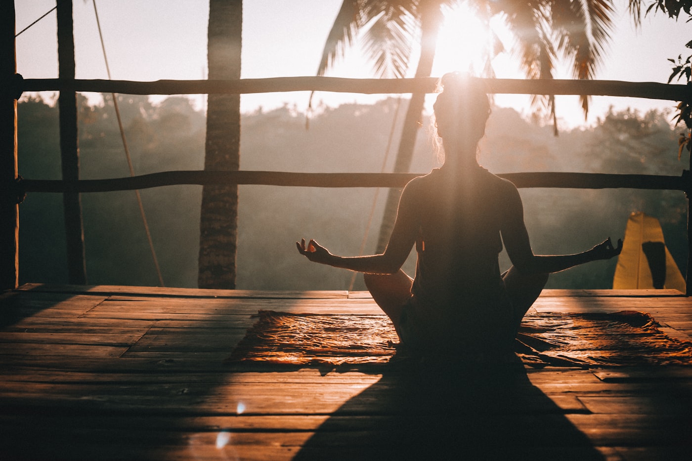 Meditation at sunrise on a wooden deck